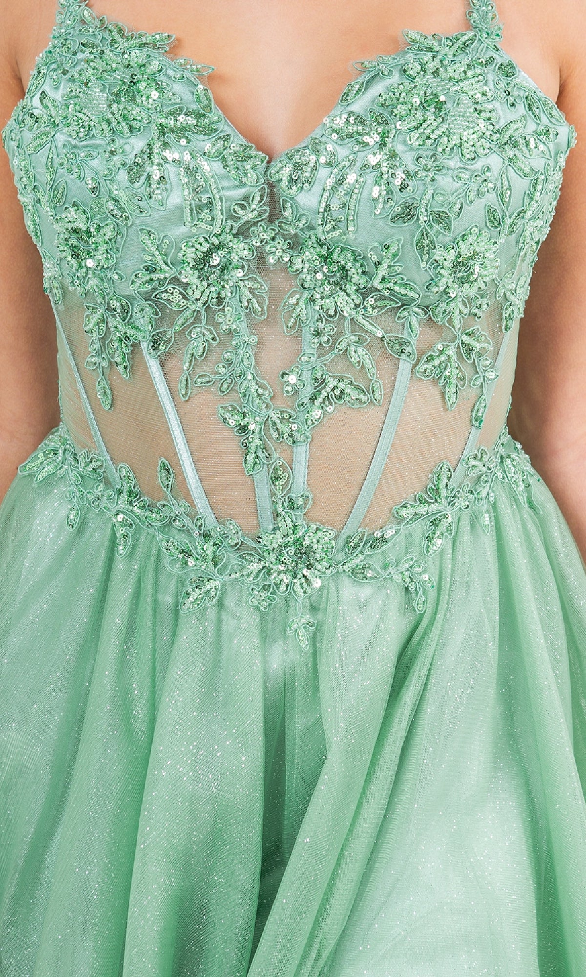 A close-up of a person wearing the Cinderella Couture 8238J, a light green long glitter prom dress with sheer mesh paneling and sequin floral embroidery on the bodice.